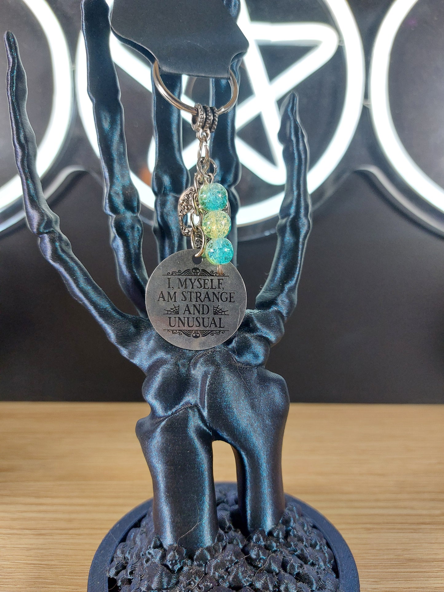 I Myself am Strange and Unusual Medal with a skull and Blue Green Bead Keychain