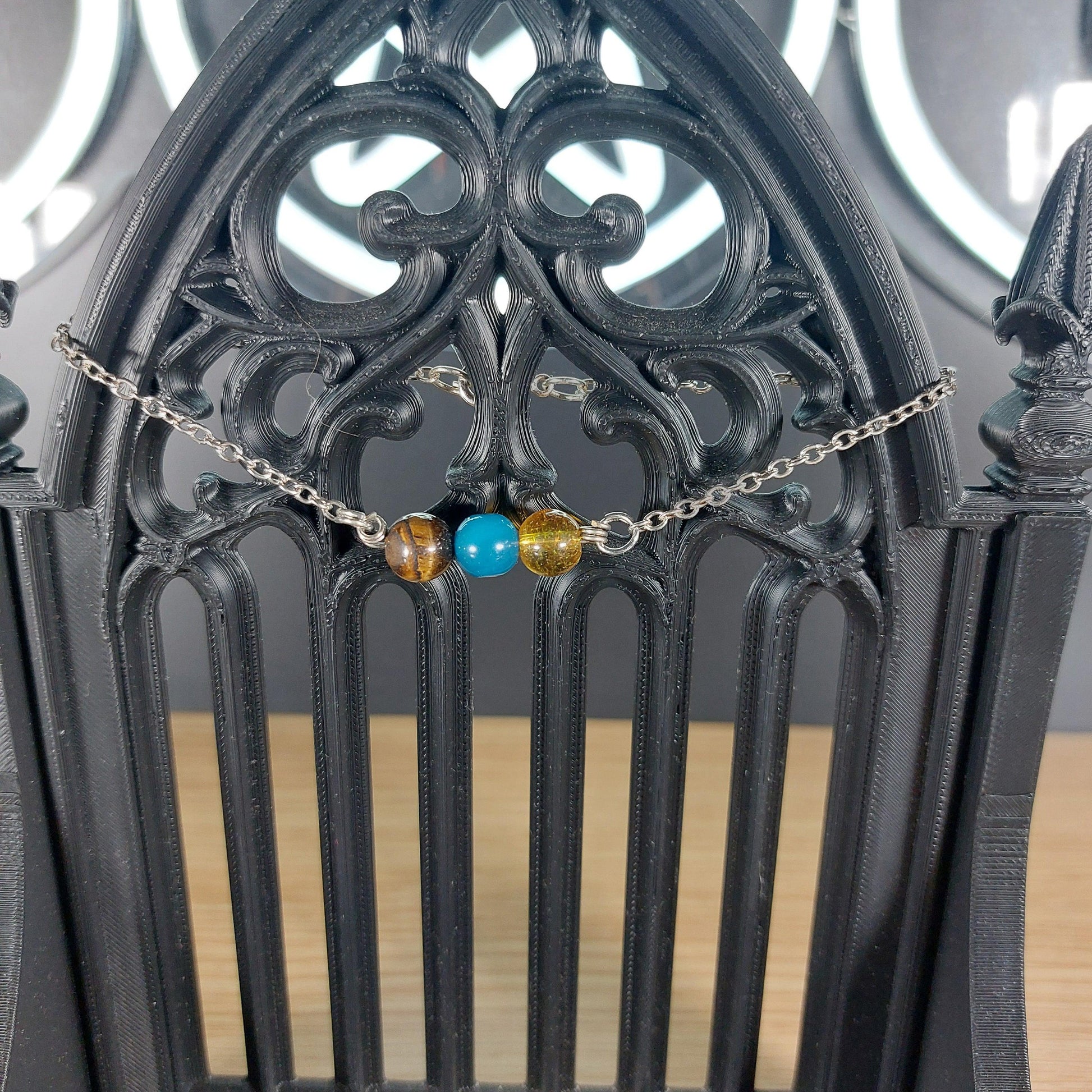 Silver-tone Gemini power stone bracelet with tiger's eye, citrine, and blue lace agate beads.