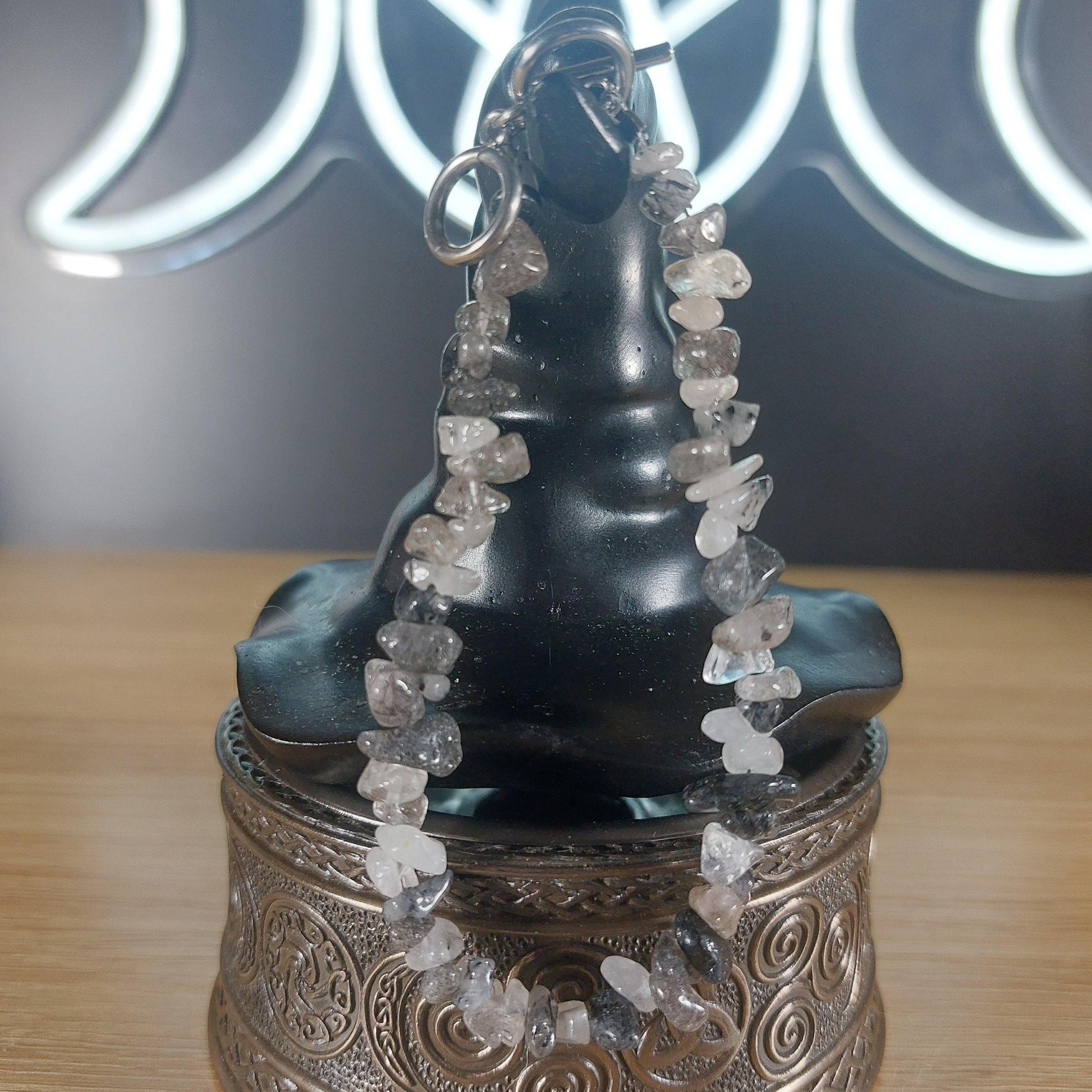 Smoky Quartz crystal chip bracelet with stainless steel toggle clasp, displayed on a black witch hat stand.
